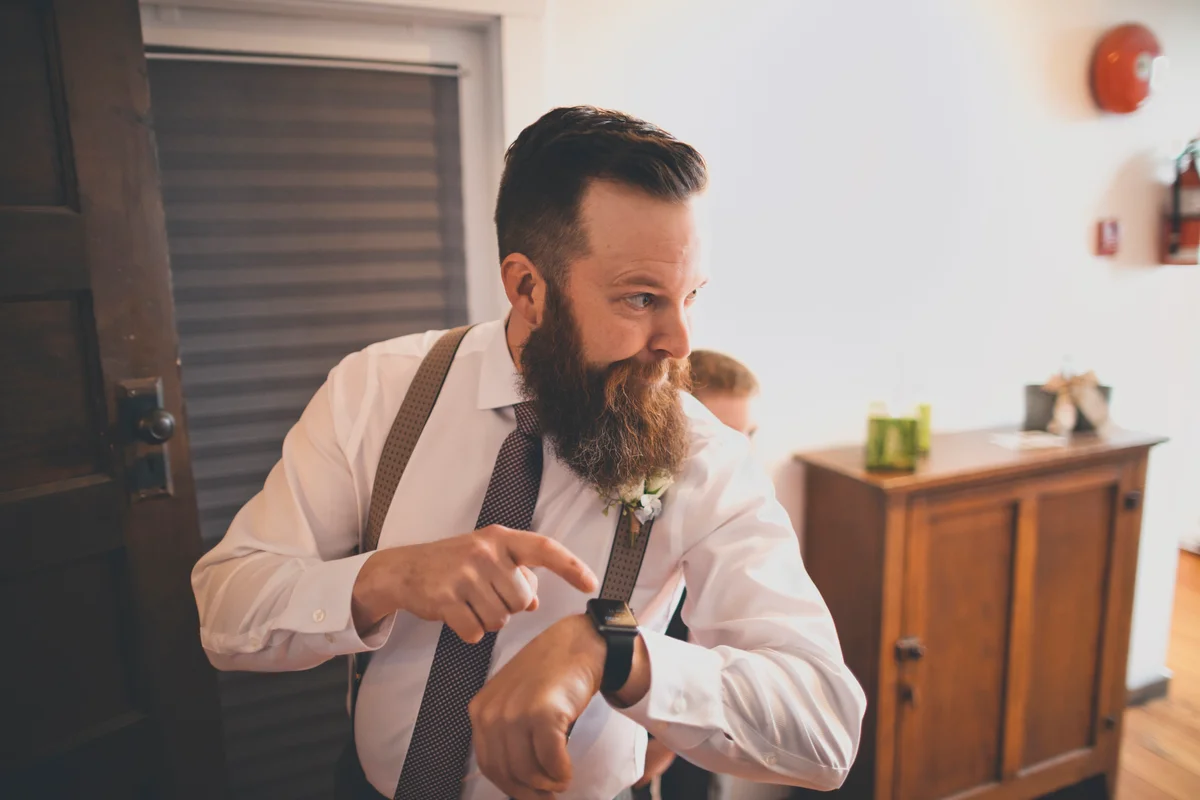 groomsman checking watch