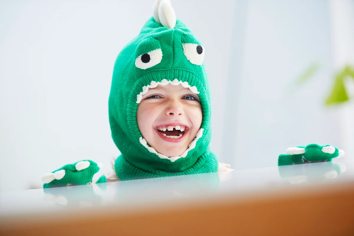 Young girl dressed up as dinosaur
