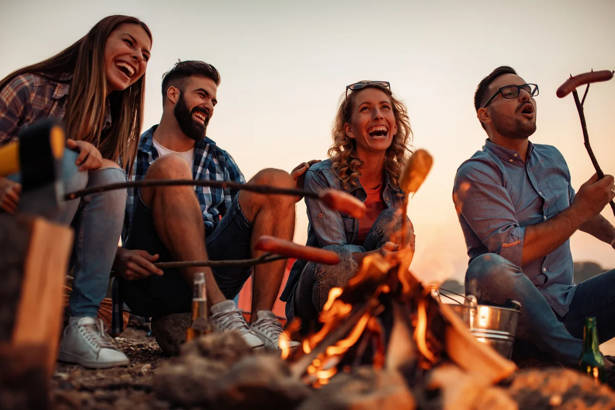 cooking hotdogs over a campfire