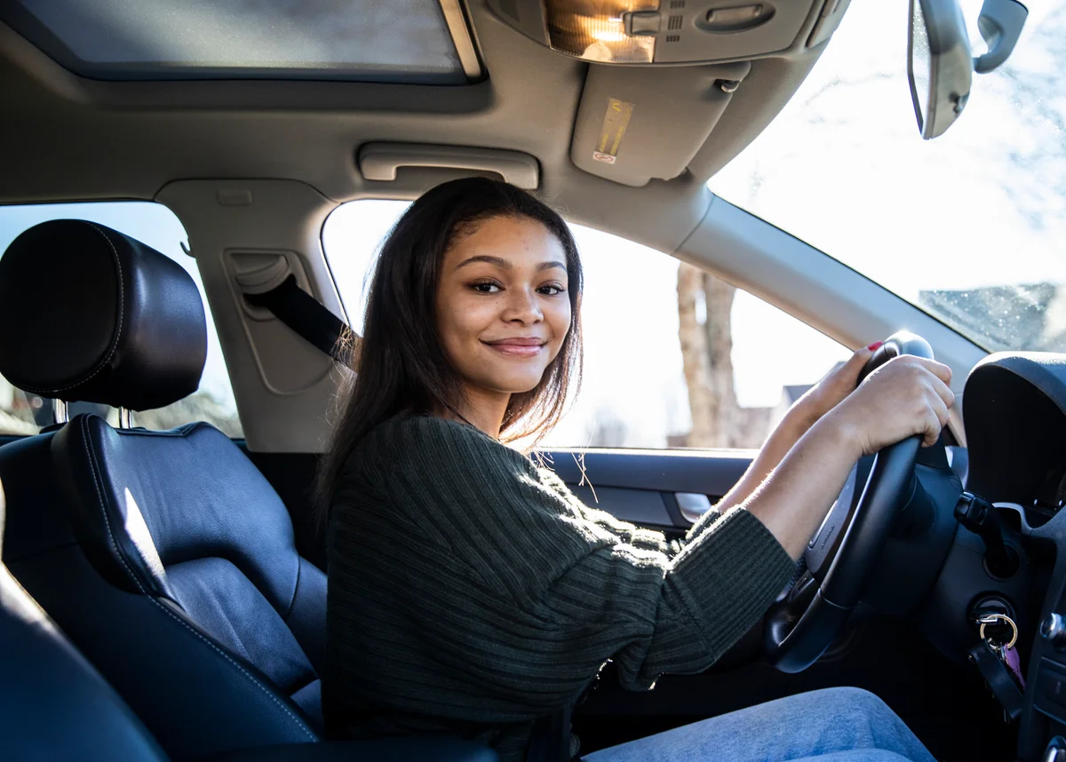 smiling woman in car
