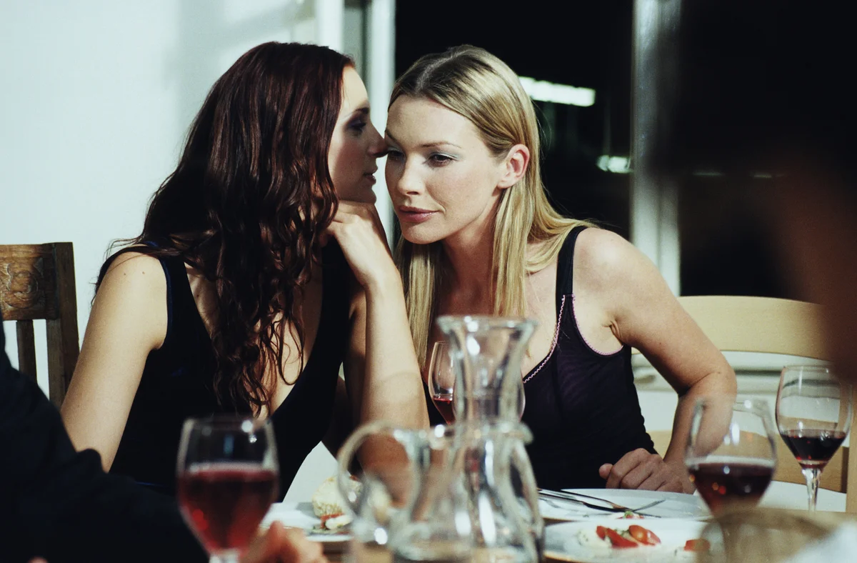 two women dressed in black at a party