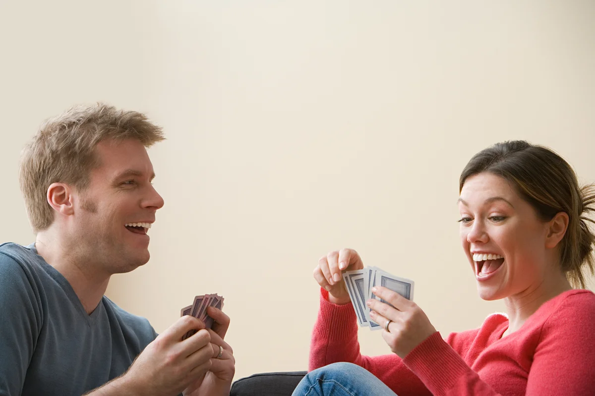 Couple having fun playing cards