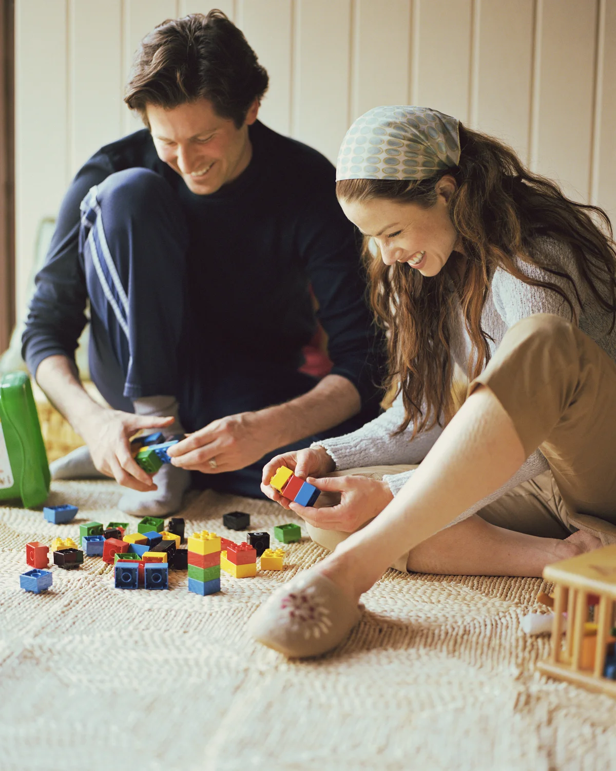Couple happily playing with legos