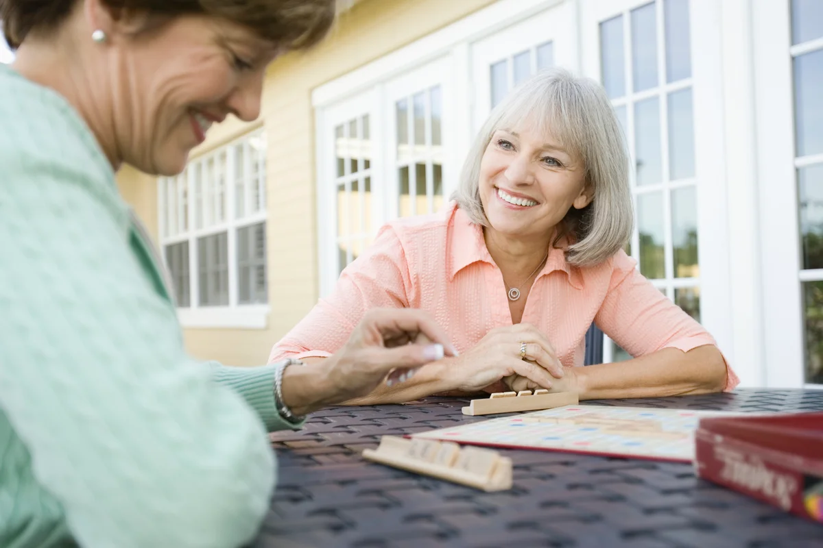 Two senior women playing Words With Friends or Scrabble-like game