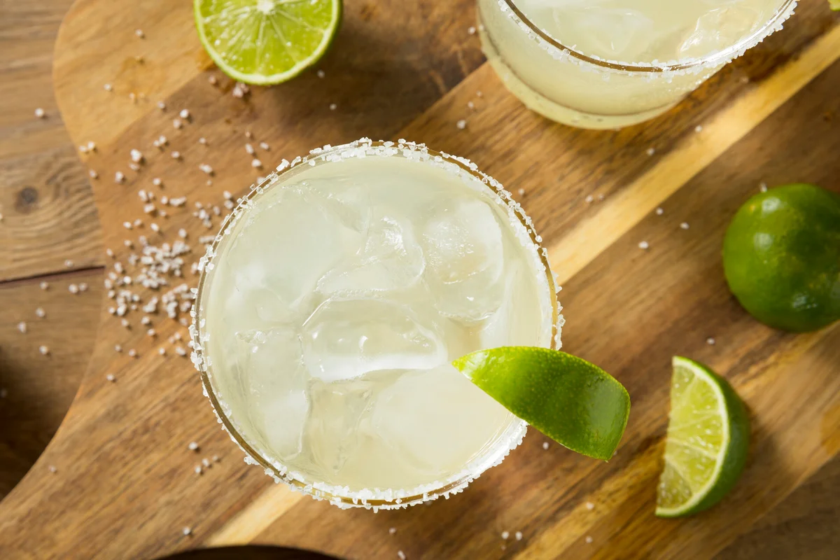 Margarita mocktail glass with salted rim & lime garnish