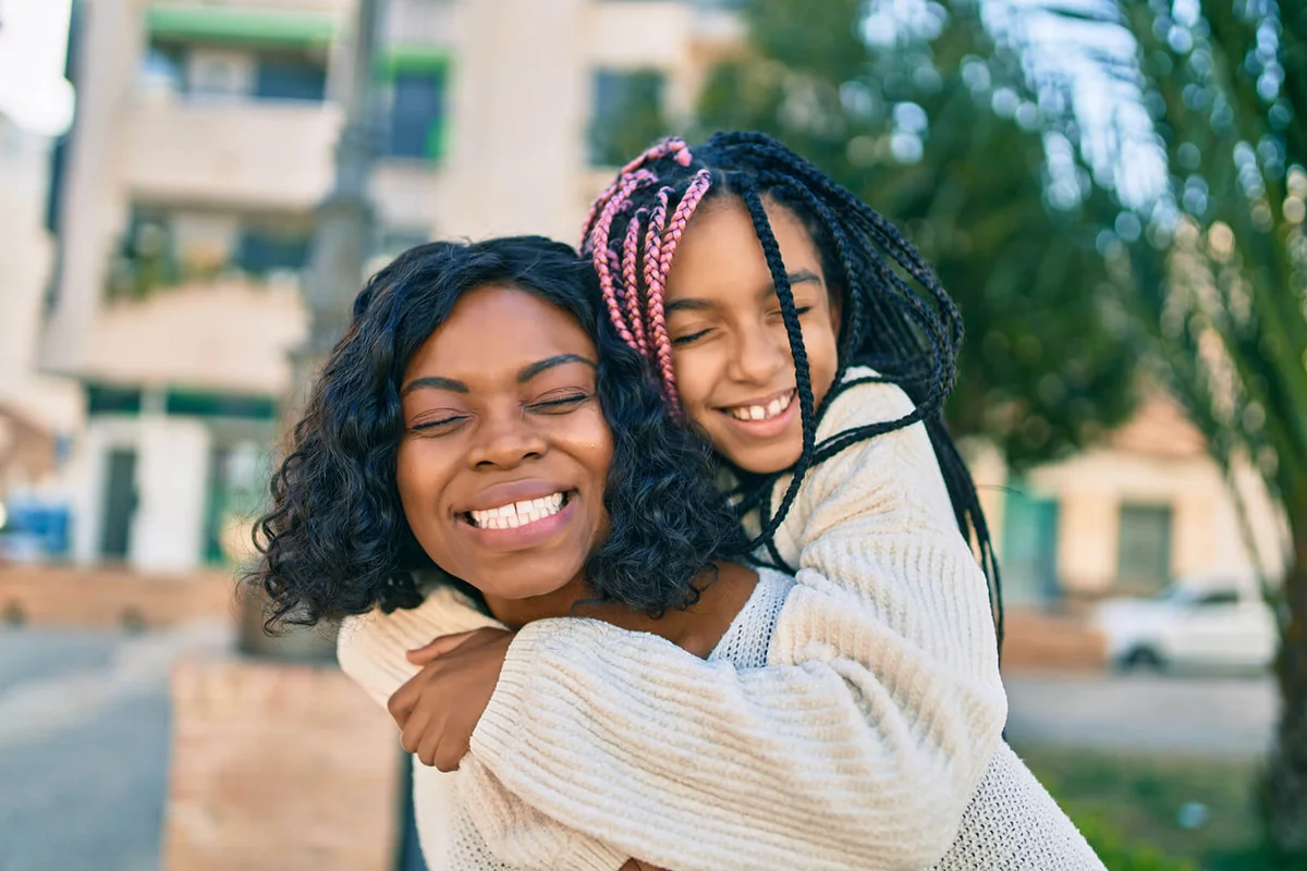 mother giving daughter piggyback ride