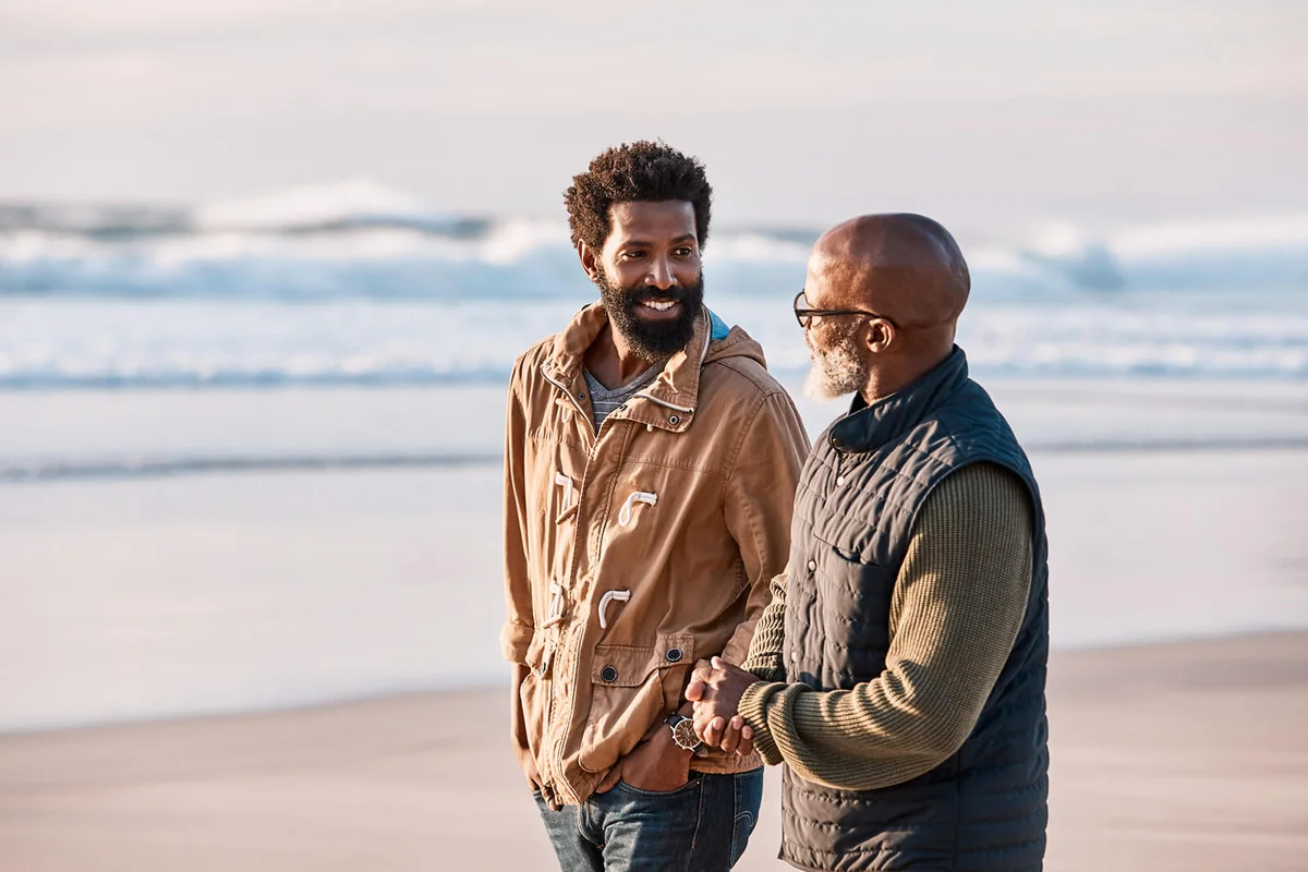 man going for a walk along the beach with his father