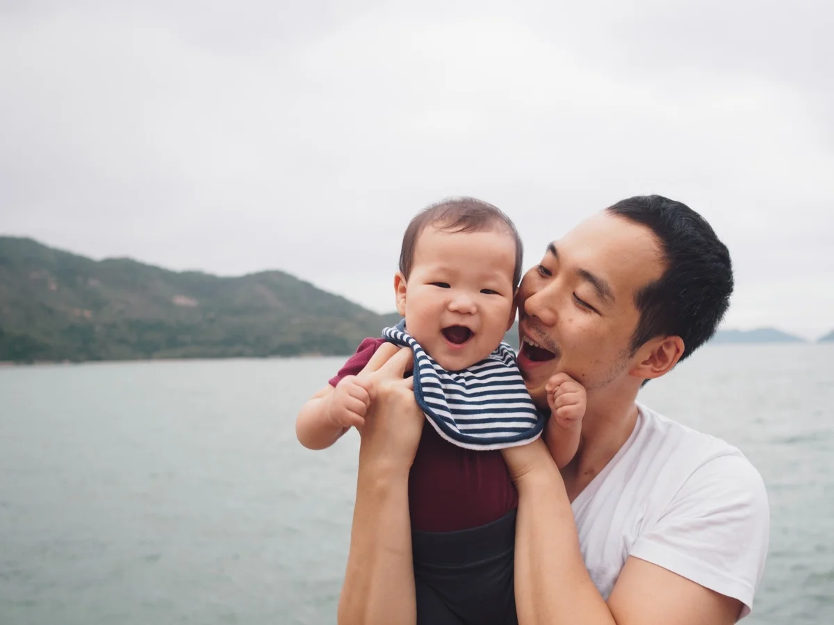 Father and happy son outside
