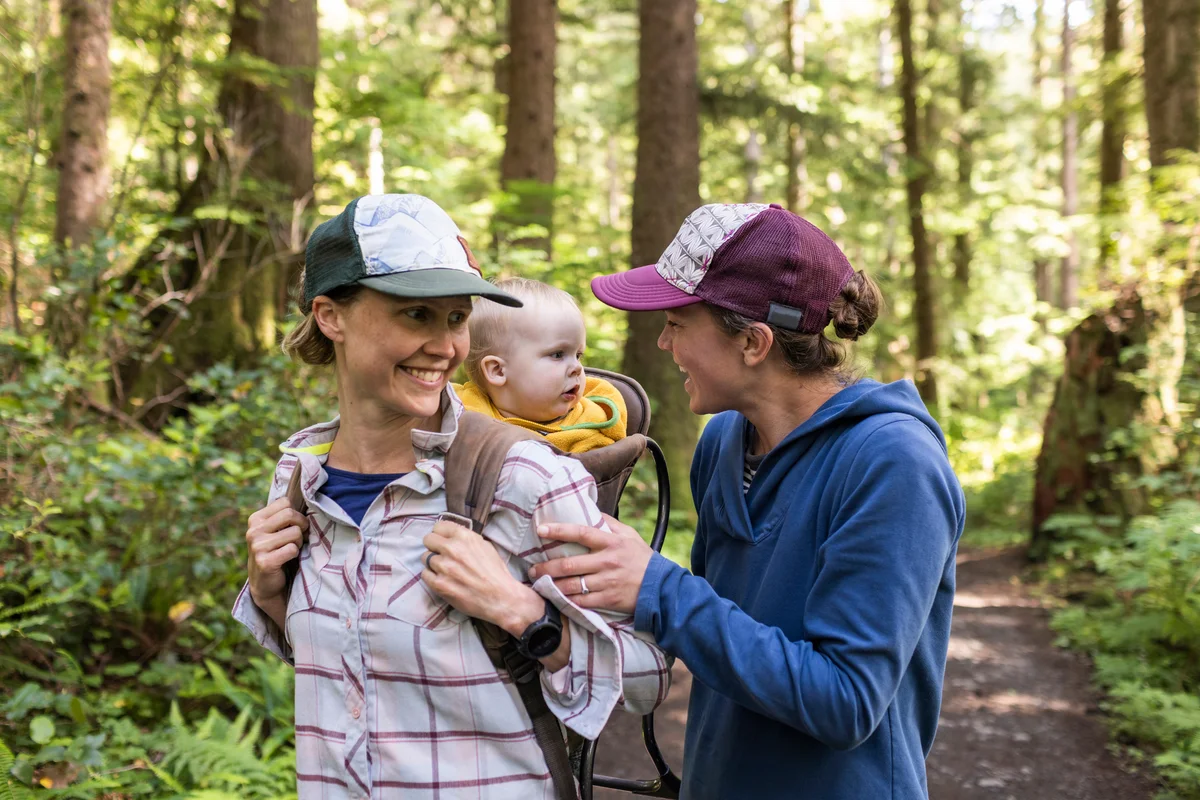 Two moms and their baby hiking in wilderness