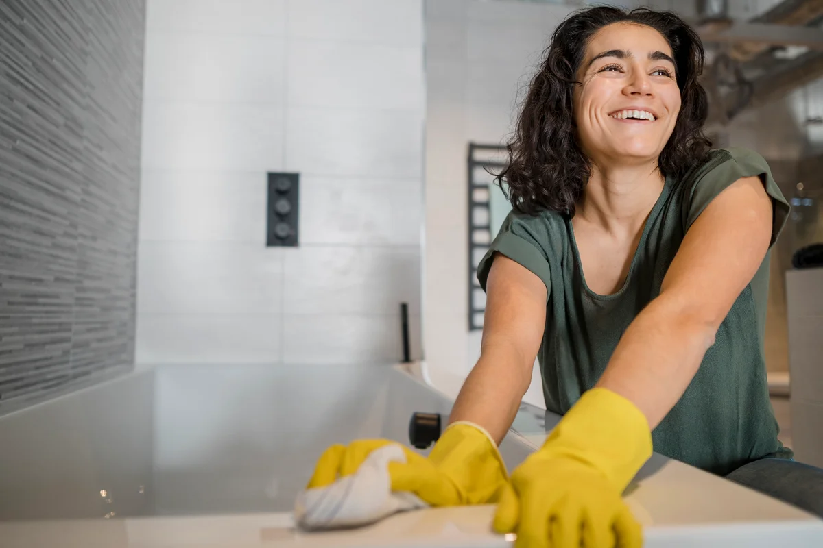 woman deep cleaning tub