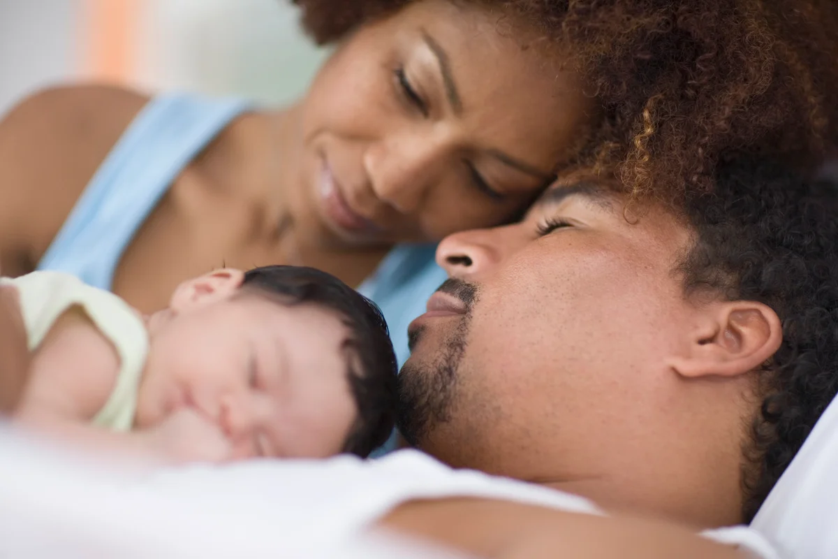 Tired parents with their newborn baby