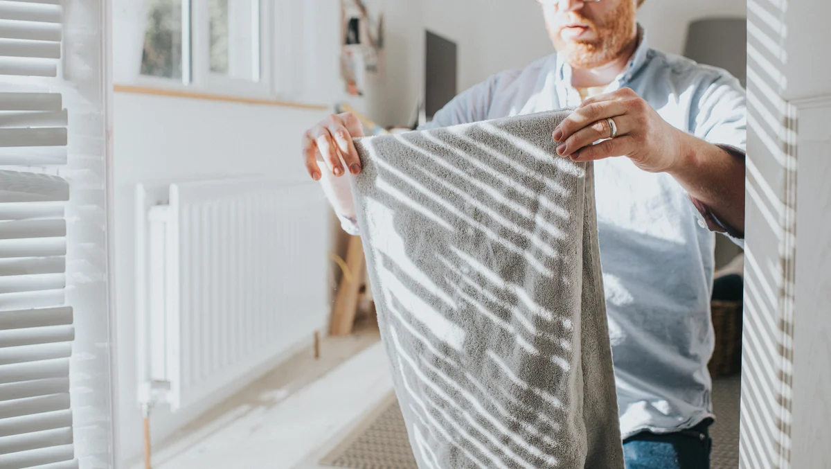 man folding towels