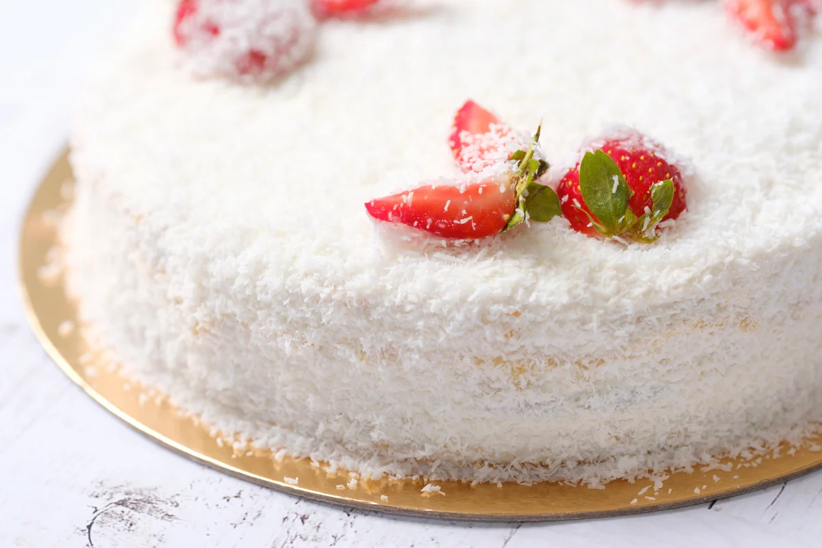 Homemade delicious sweet strawberry cake with shaved coconut