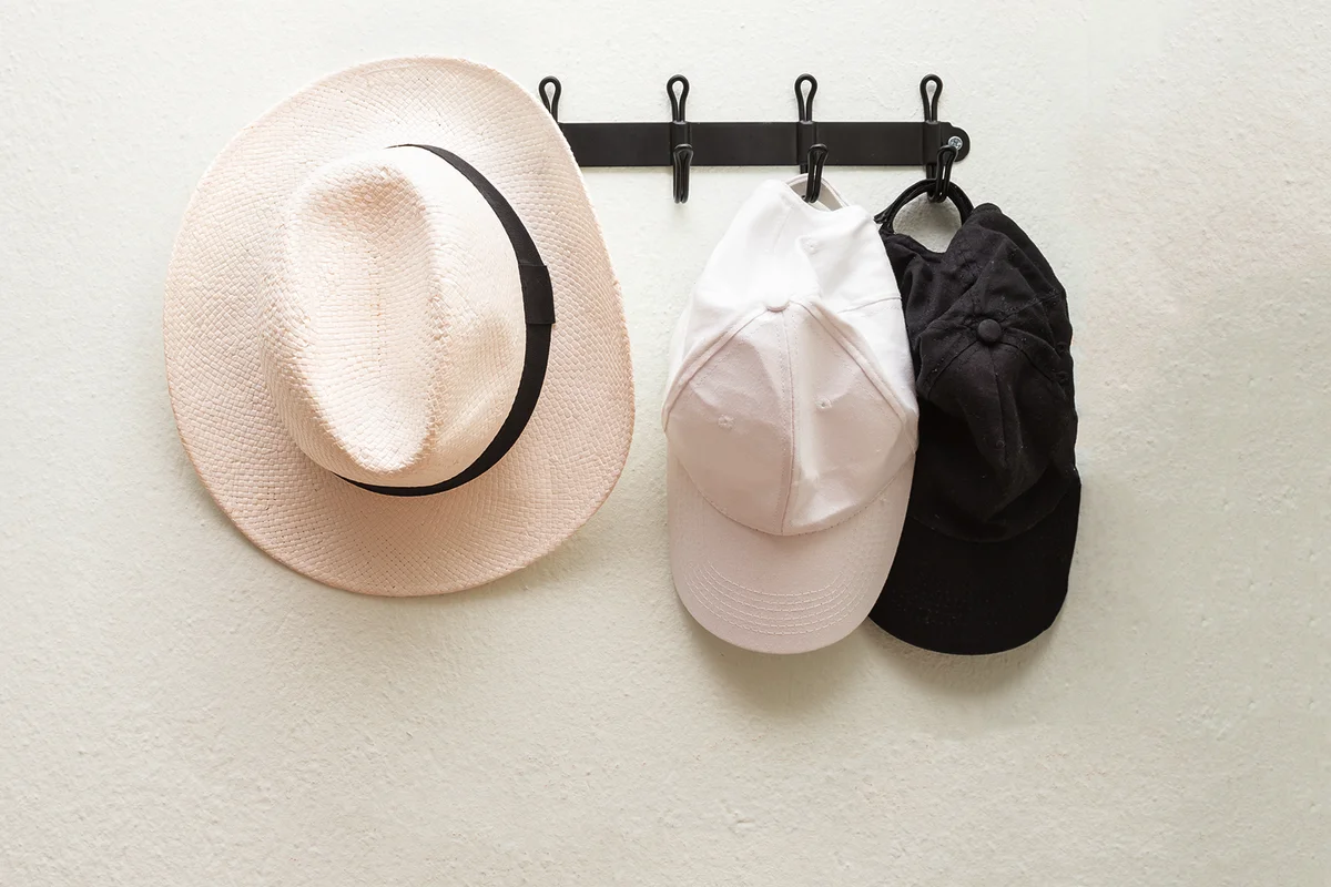 Hat and caps hanging on Wall