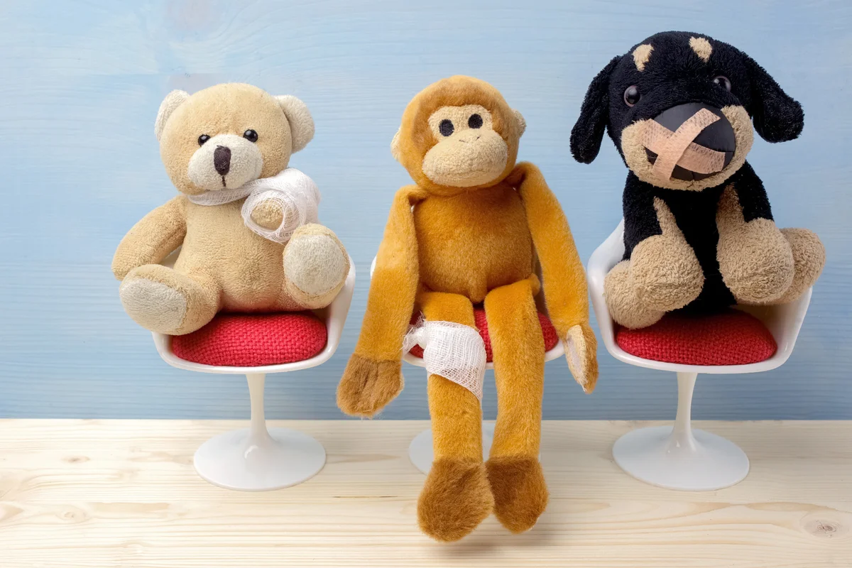 Stuffed animals sitting on chairs