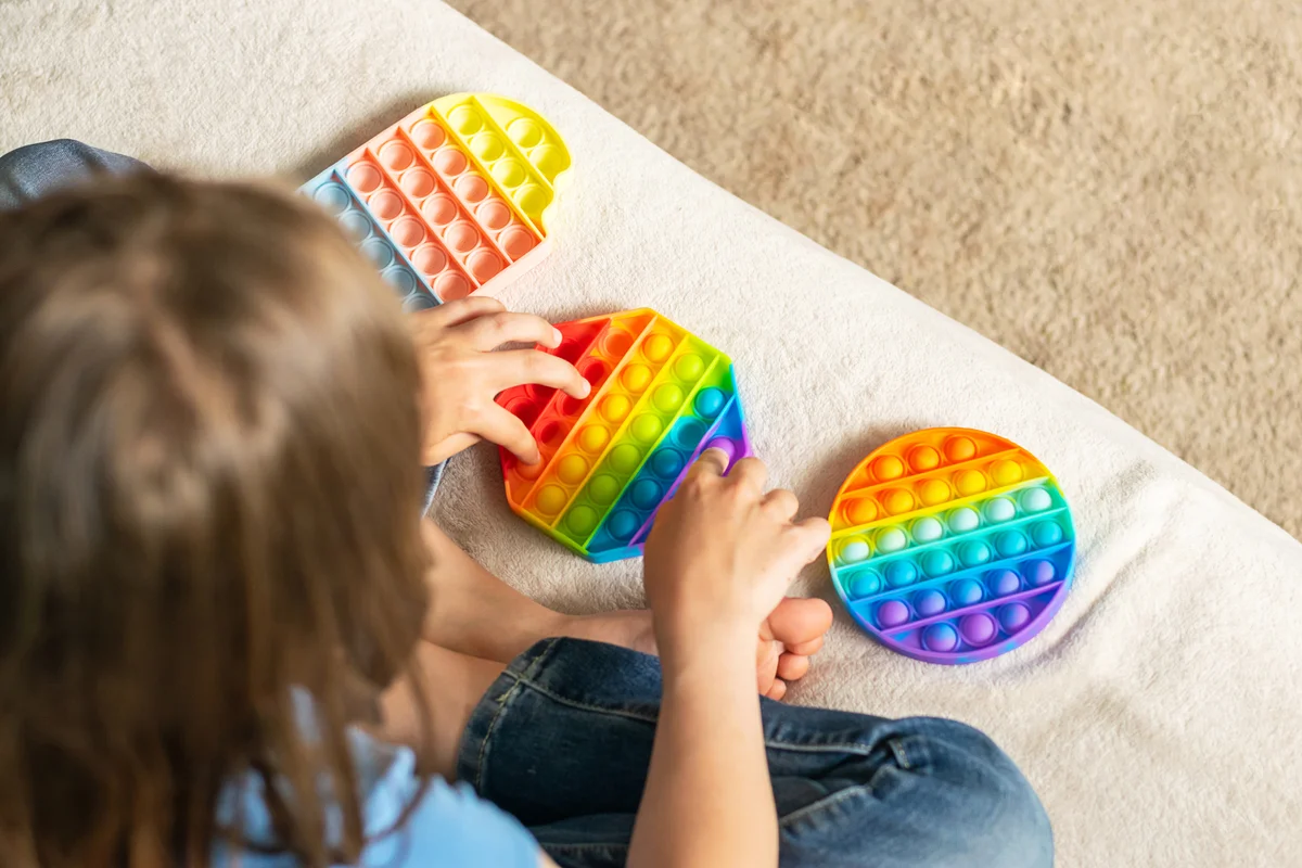 kid playing with fidget toys