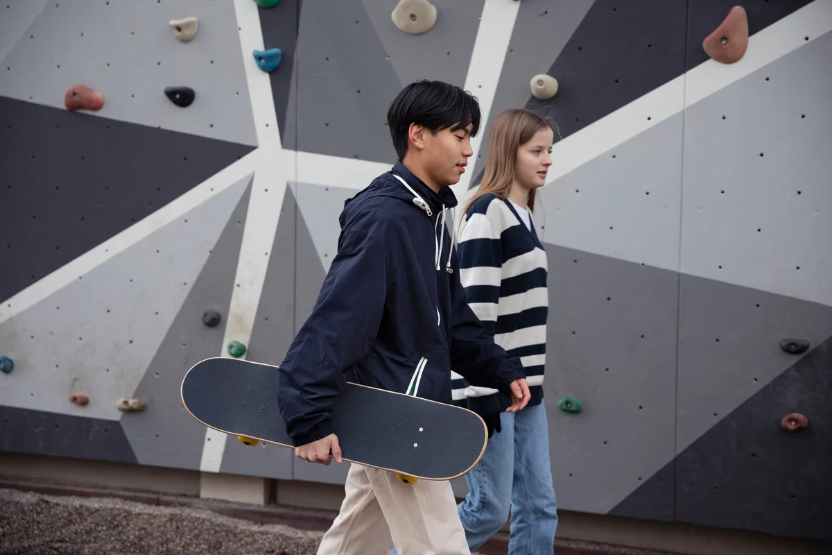 Young 15-16 year olds at skate park holding hands