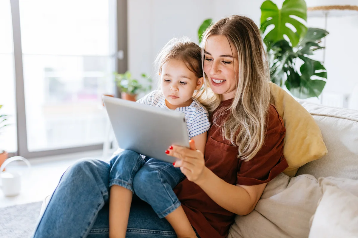 Mother and daughter using a digital tablet together