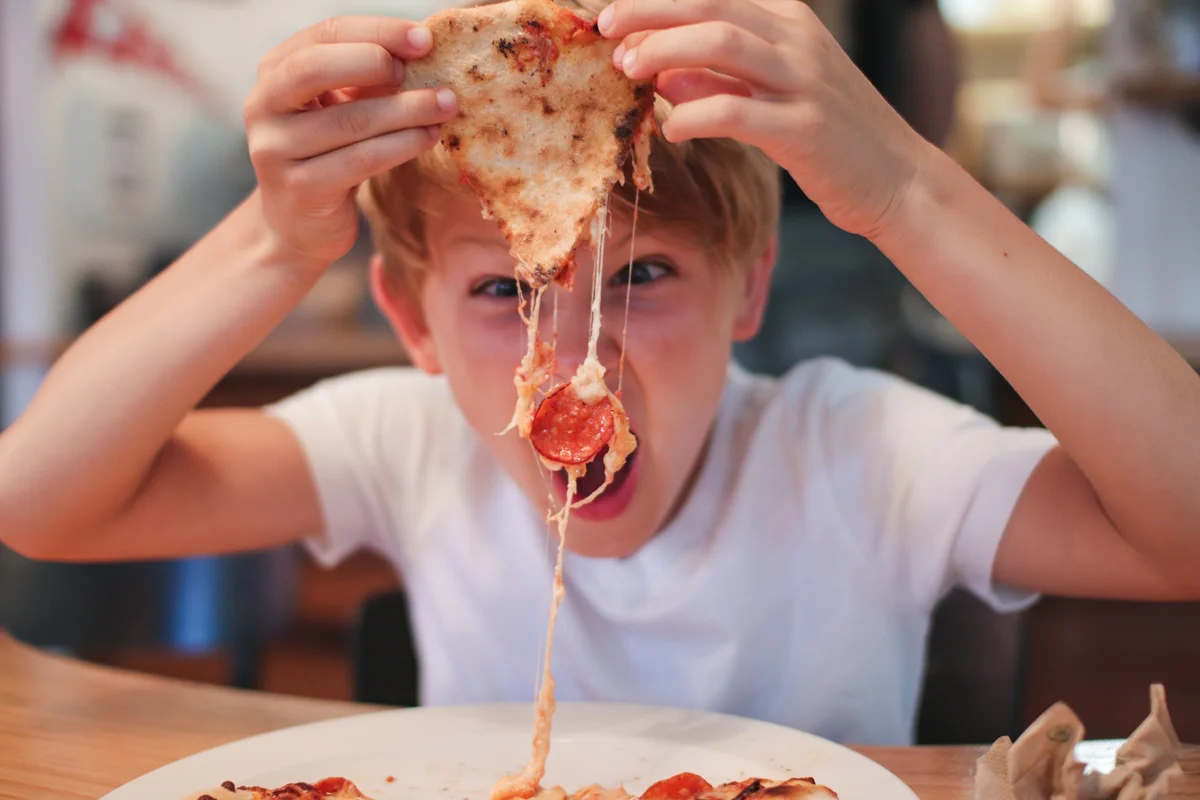 boy eating pizza
