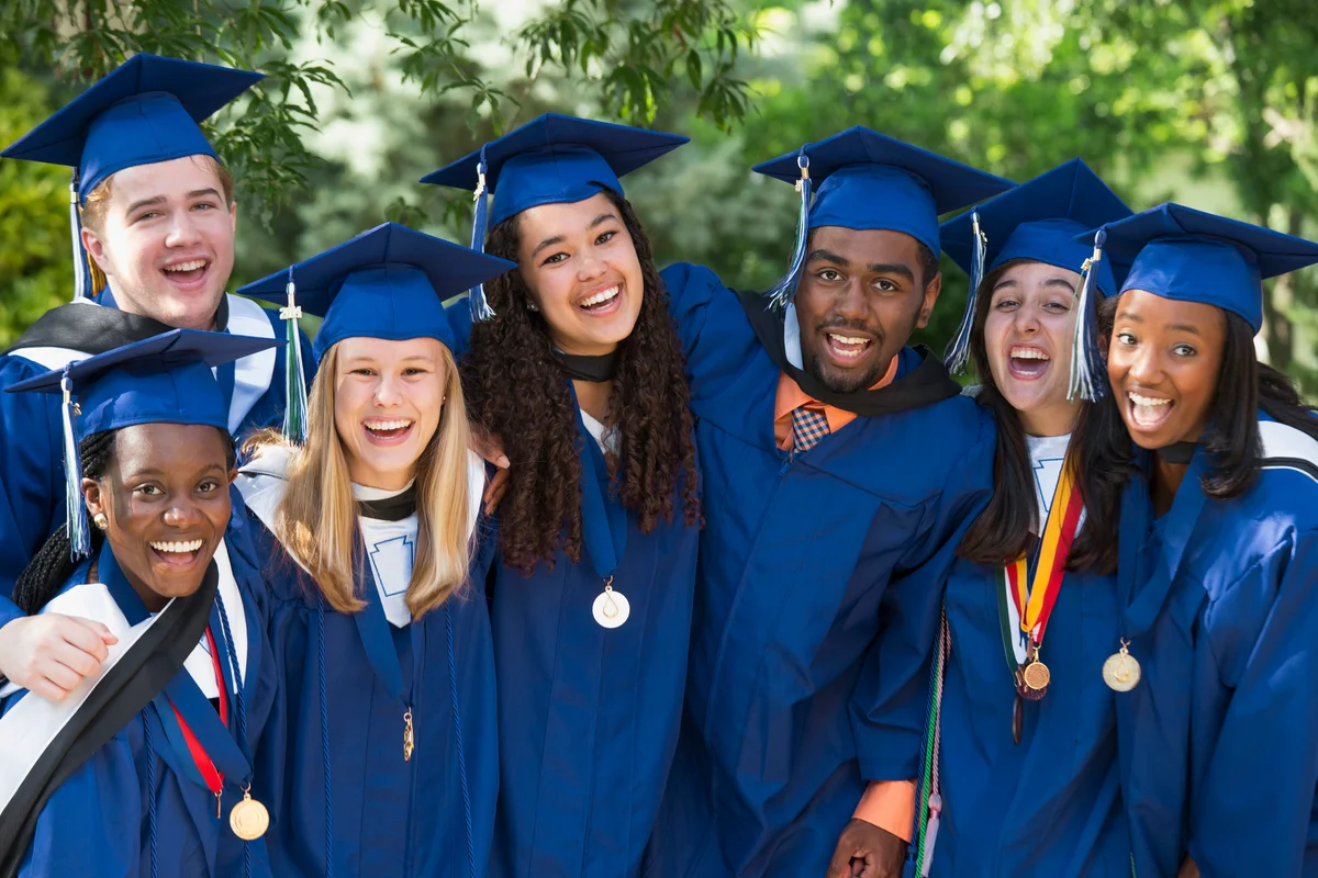 Group of graduations wearing tassels on right