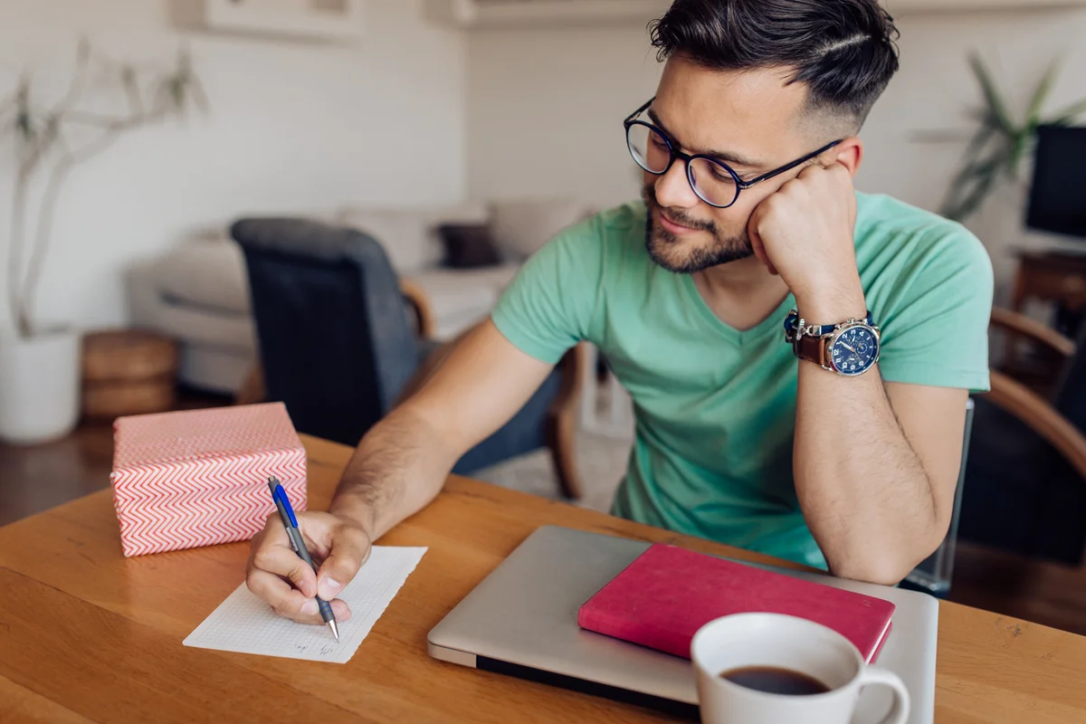 Guy writing a love note