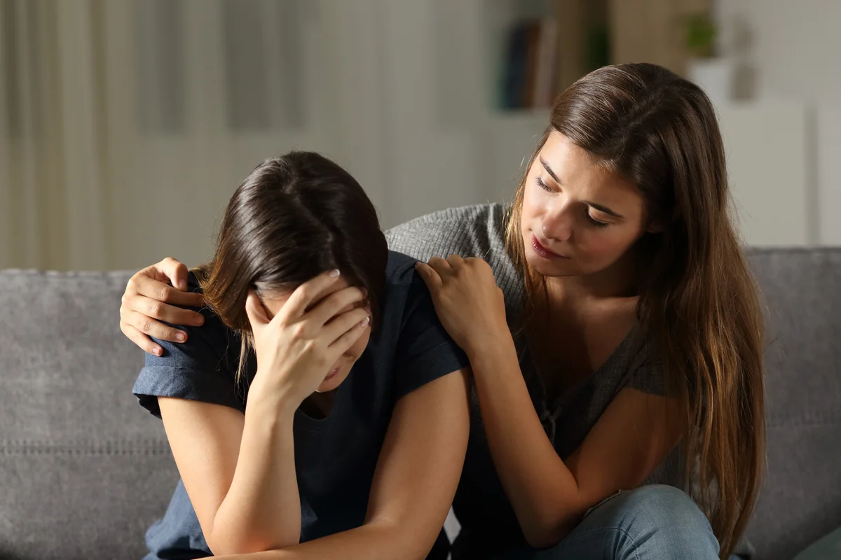 Girl comforting her friend in grief