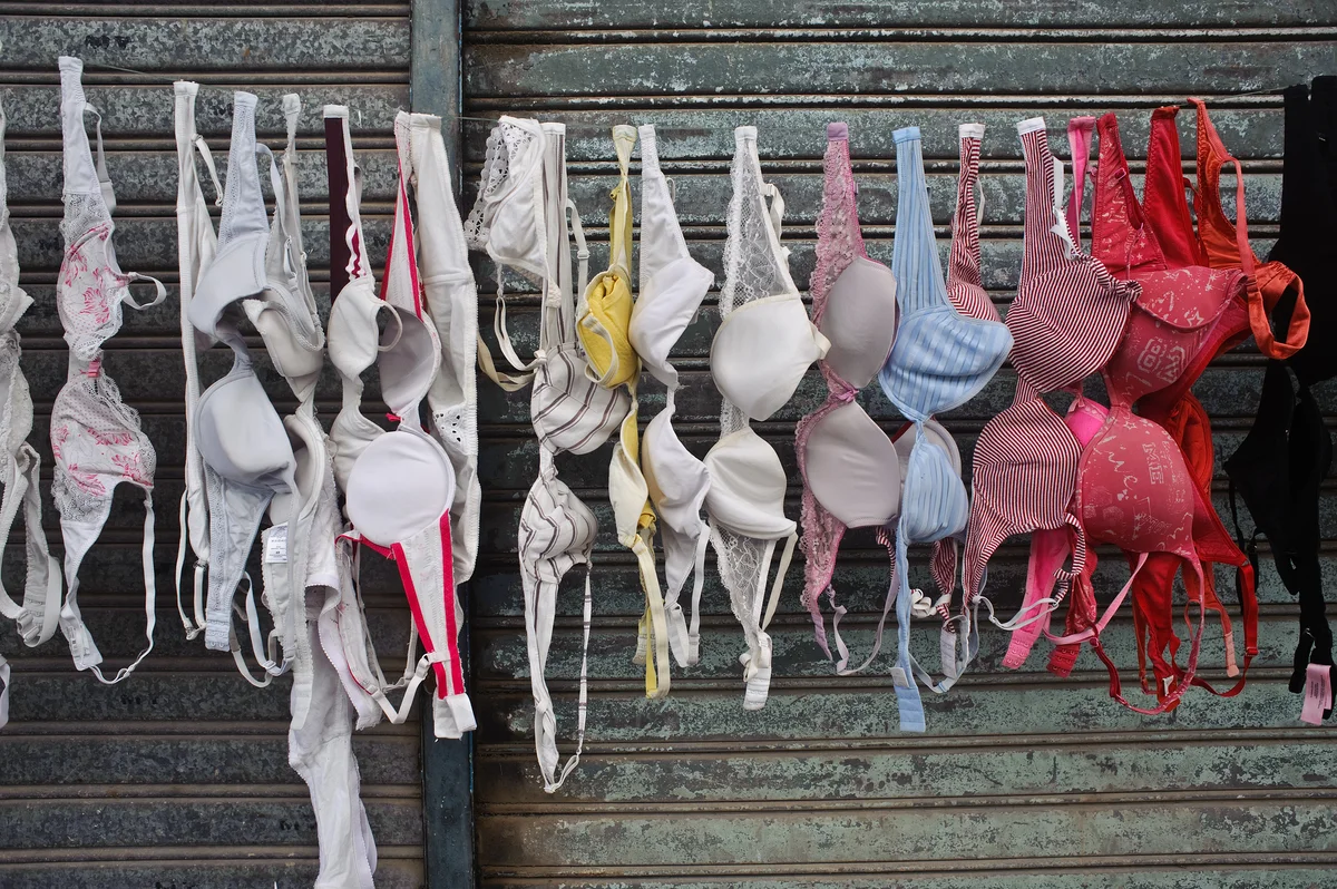 Used bras hanging on clothing line