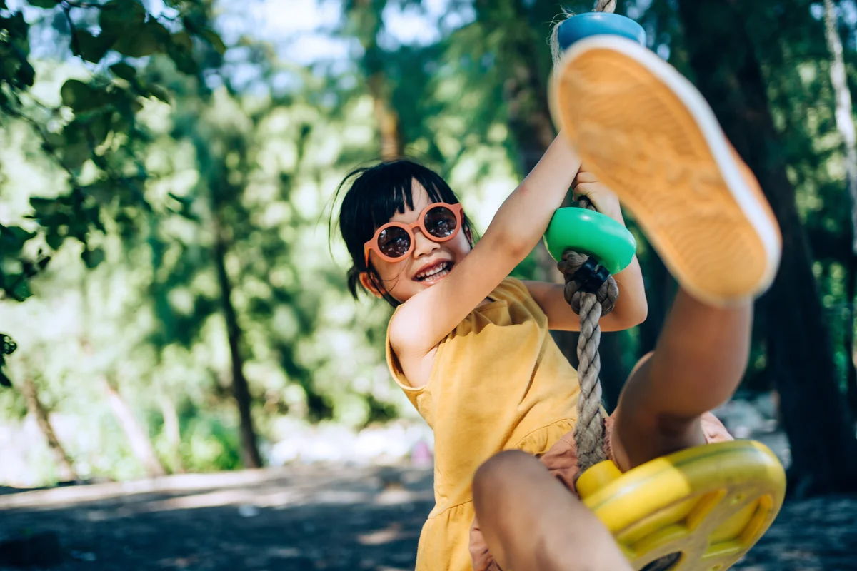 little girl on a swing