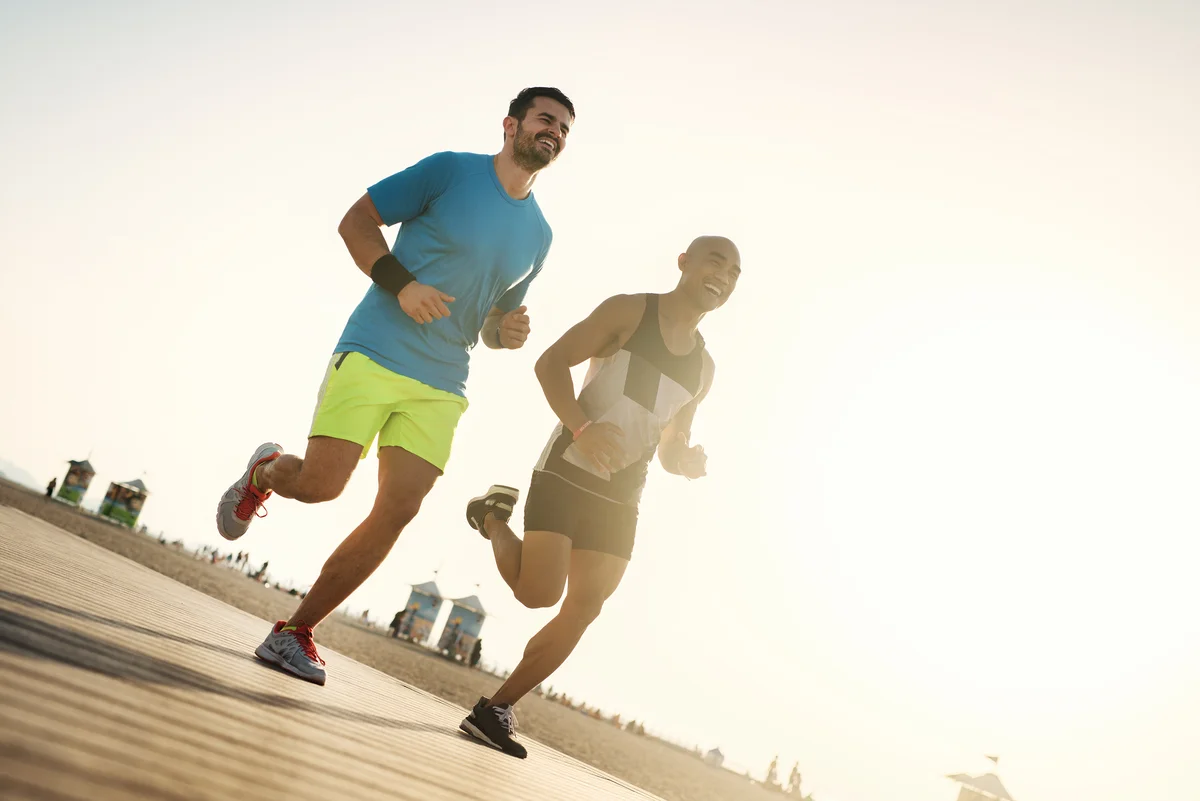 Male couple running on Delaware beach
