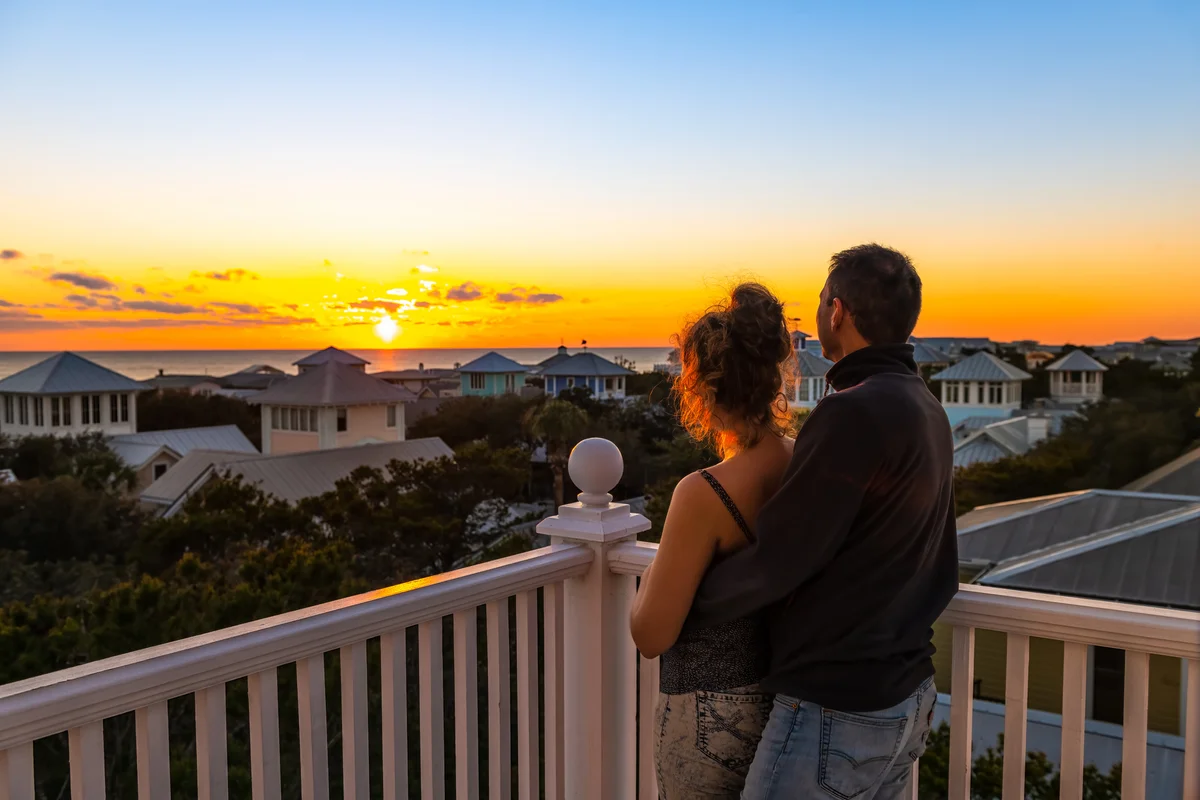 Florida couple watching sunset on romantic balcony