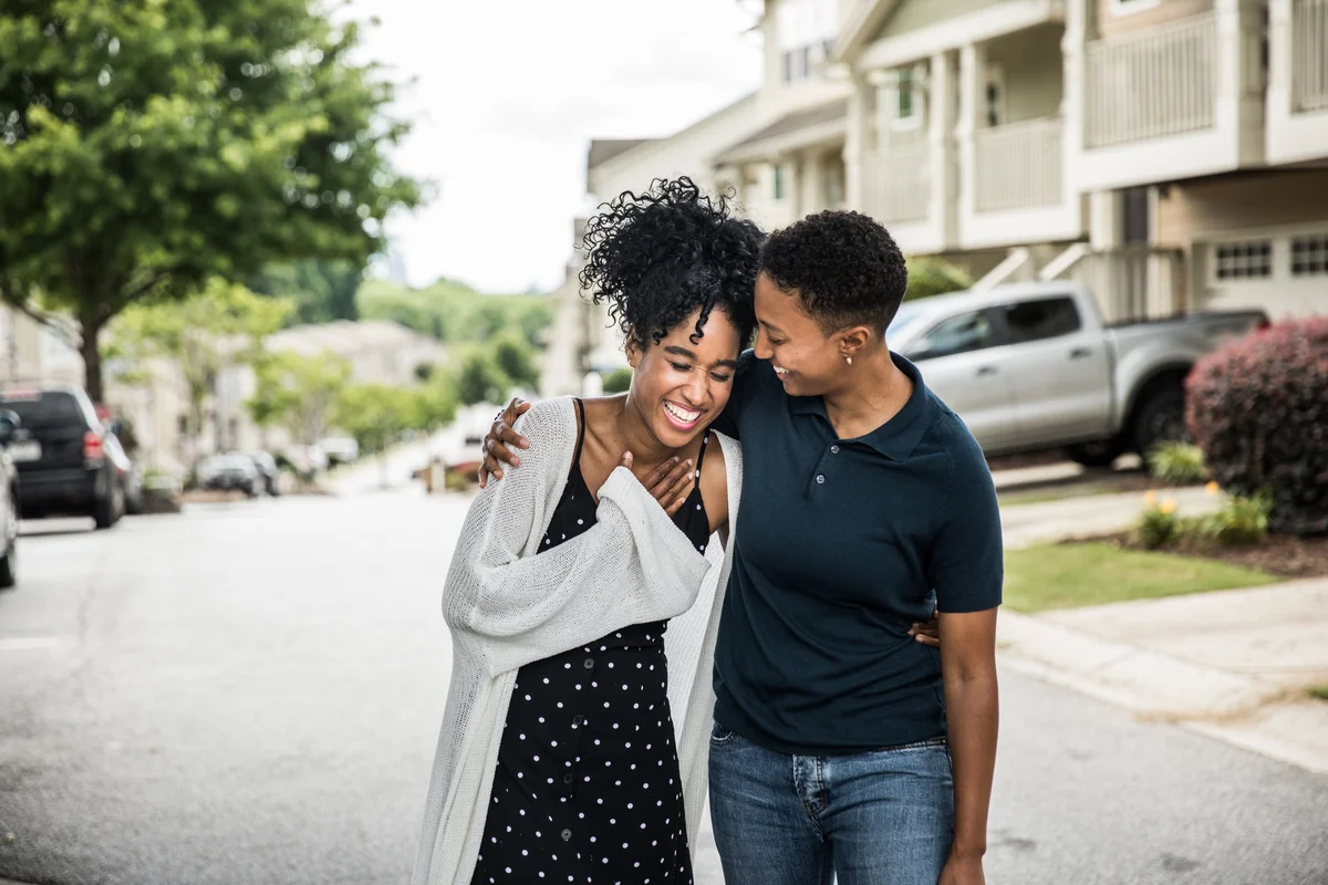 Lesbian couple walking through residential Georgia neighborhood