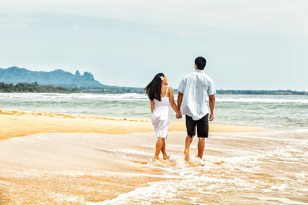 Hawaiin couple enjoying romantic beach walk