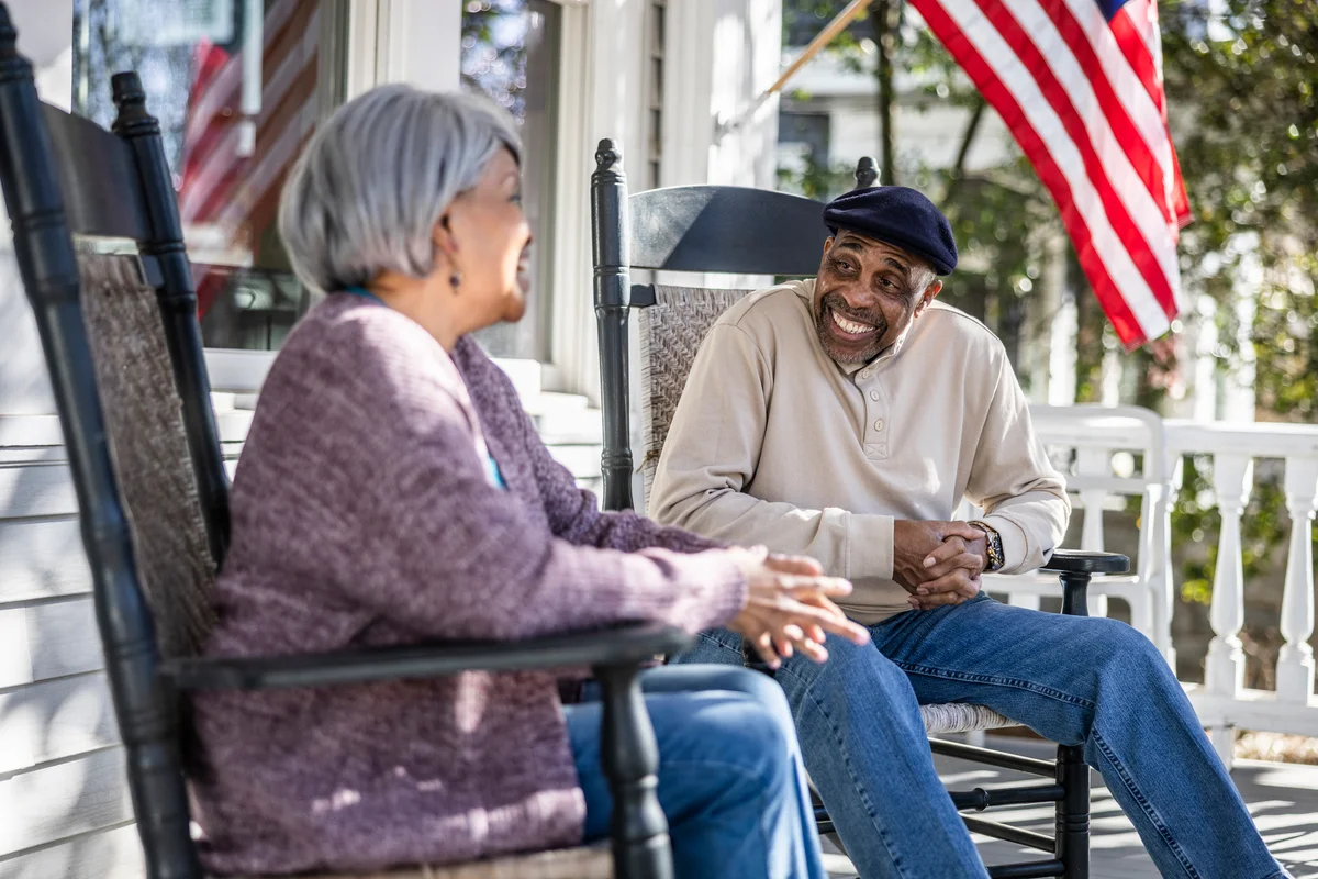 Happy older couple sitting on porch