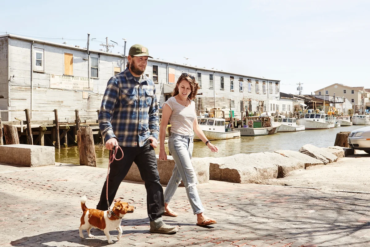 Happy Maine couple walking dog in town