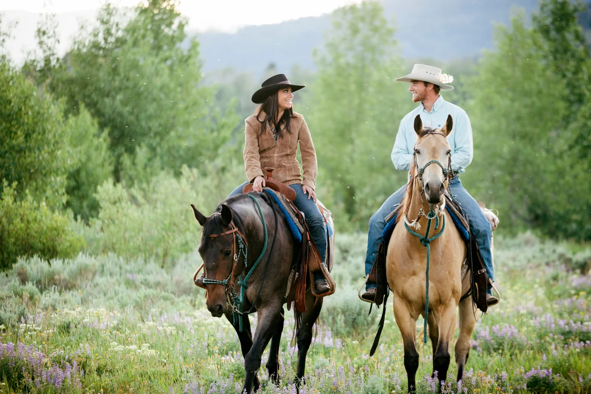 Montana rancher couple riding horseback
