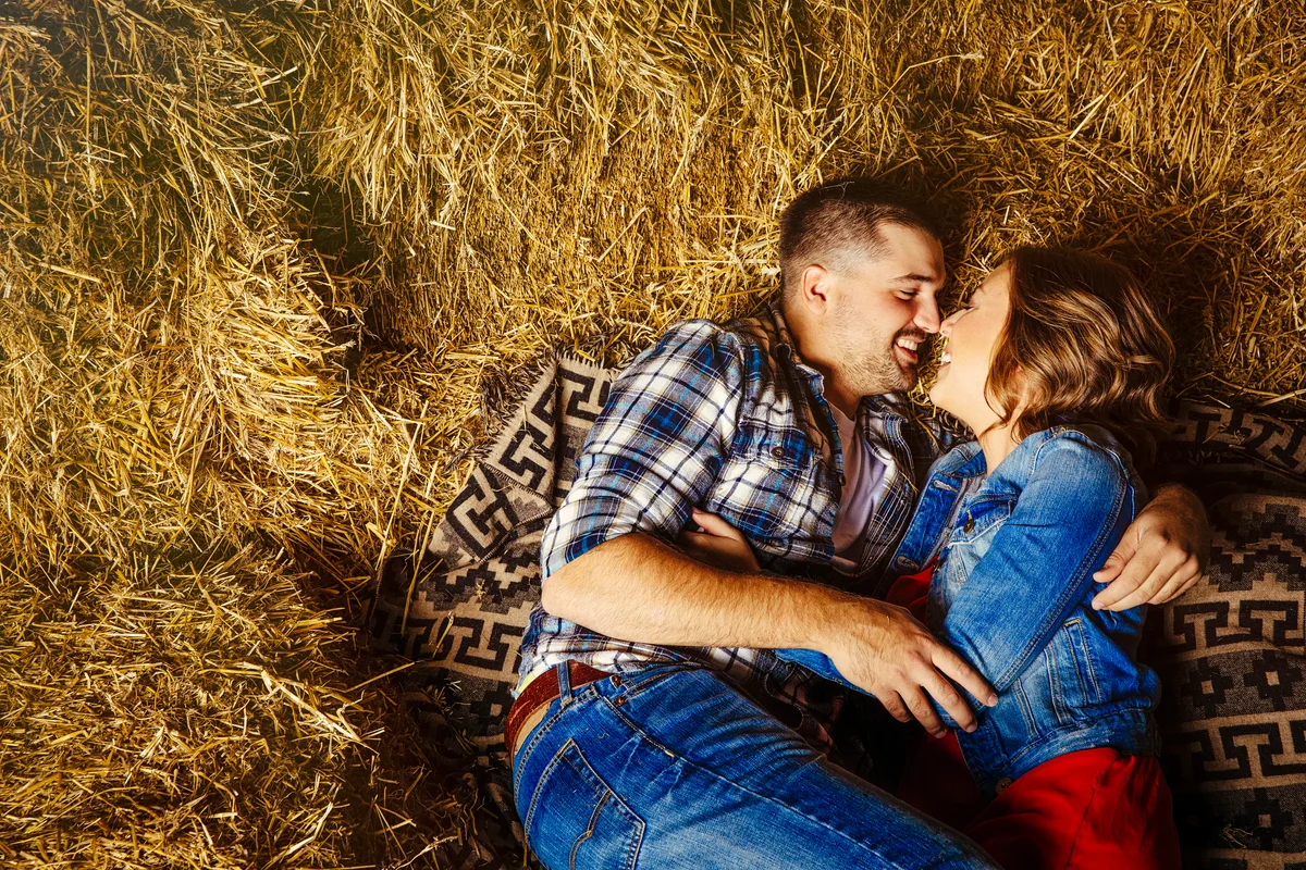 Nebraska couple kissing in haystacks