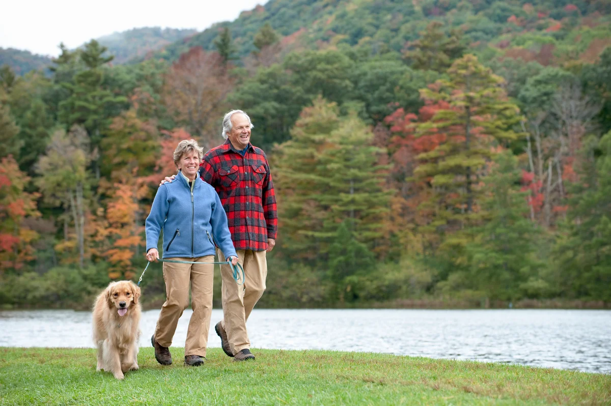 Older couple on walk with dog in Vermont
