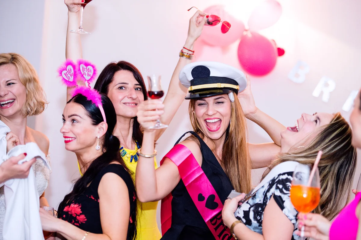 Cheerful bride and bridesmaids celebrating