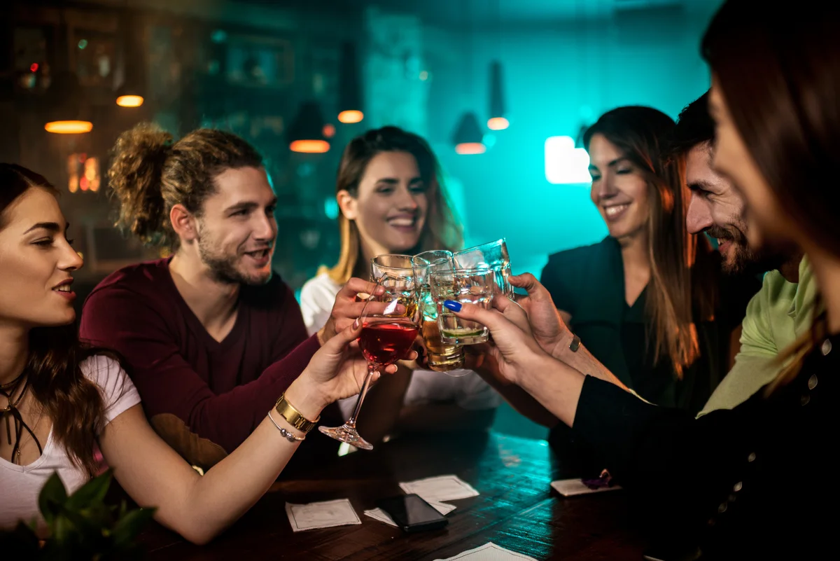 Friends enjoying drinks in a speakeasy