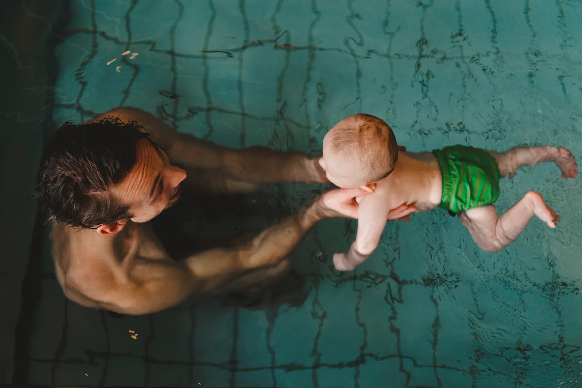 Baby and parent swimming