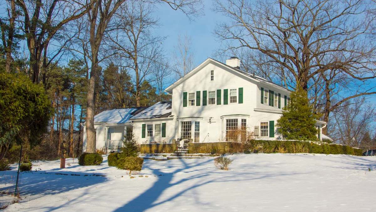 Large historic white home in winter setting