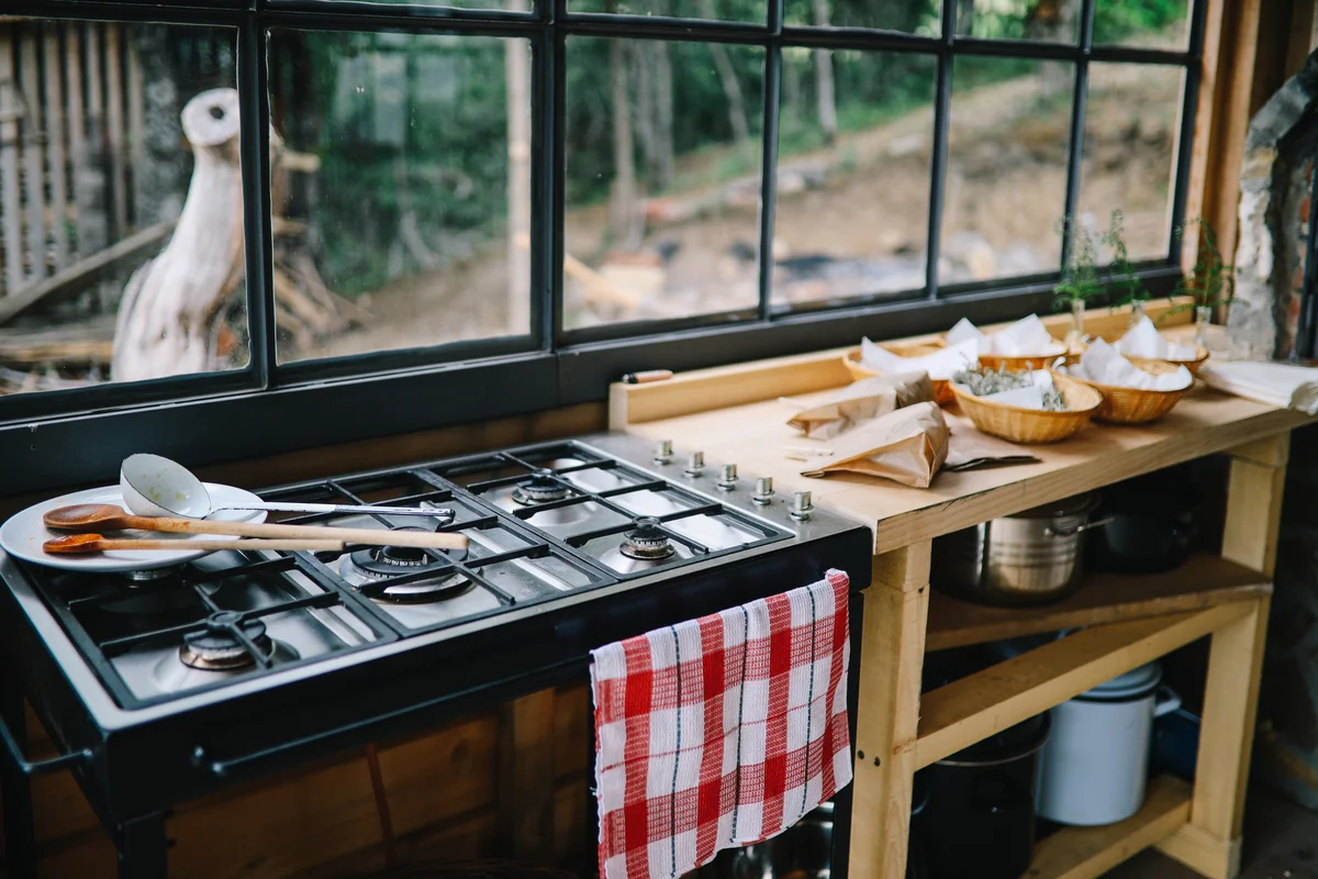 Summer kitchen closeup showing gas stove and workstation