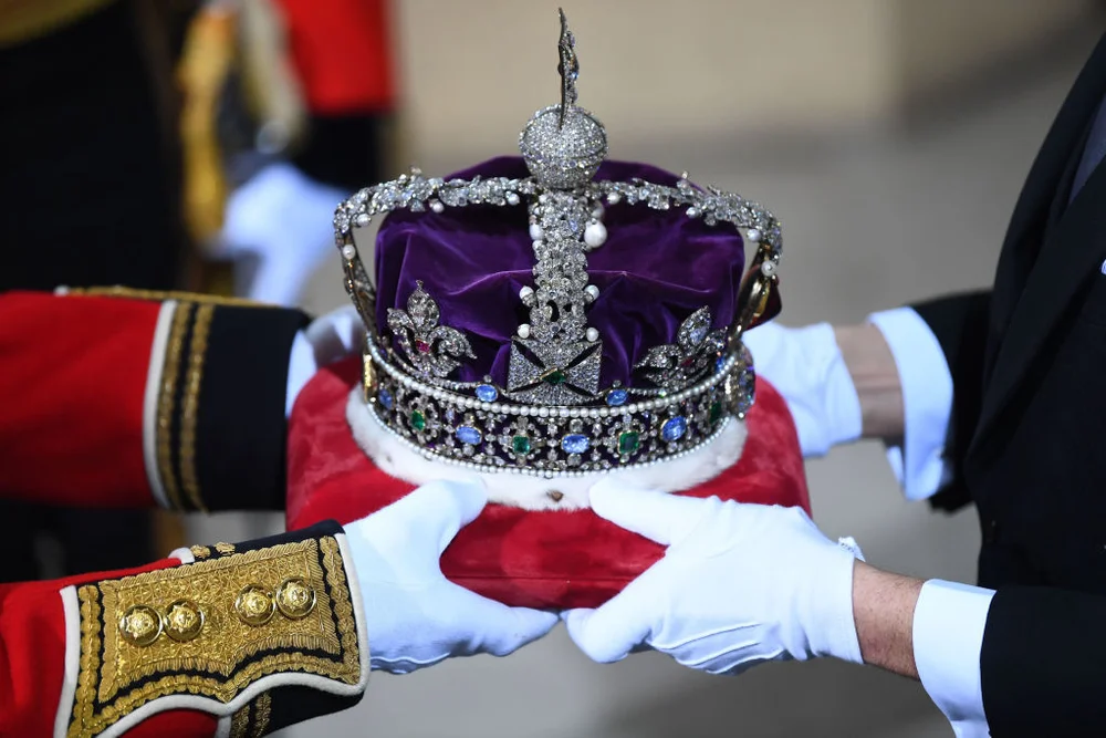 LONDON, ENGLAND - DECEMBER 19: The Imperial State Crown is passed over in the Sovereign's entrance ahead of the state opening of parliament at the Houses of Parliament on December 19, 2019 in London, England. In the second Queen's speech in two months, Queen Elizabeth II will unveil the majority Conservative government's legislative programme to Members of Parliament and Peers in The House of Lords. (Photo by Victoria Jones - WPA Pool/Getty Images)
