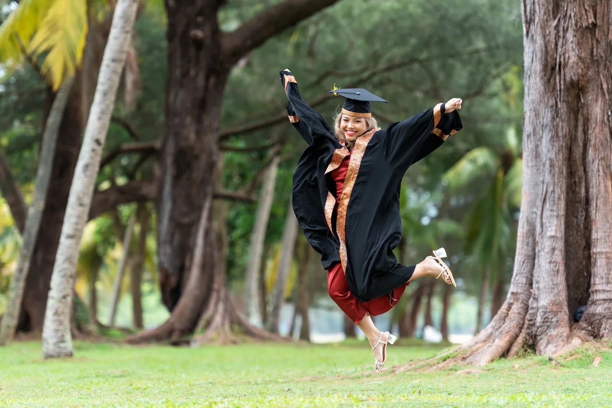 Graduate jumping for joy