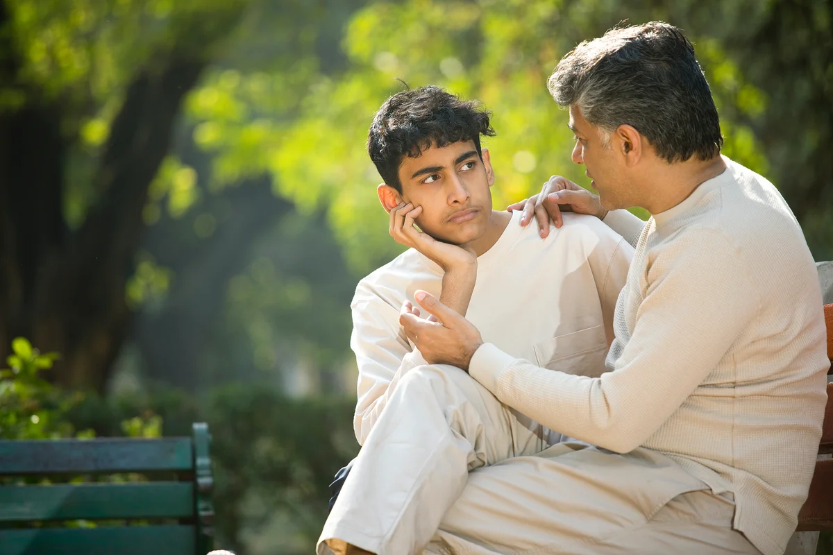 Teen and dad talking