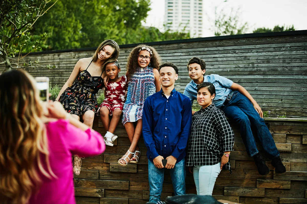 Cousins posing for family portrait after dinner party