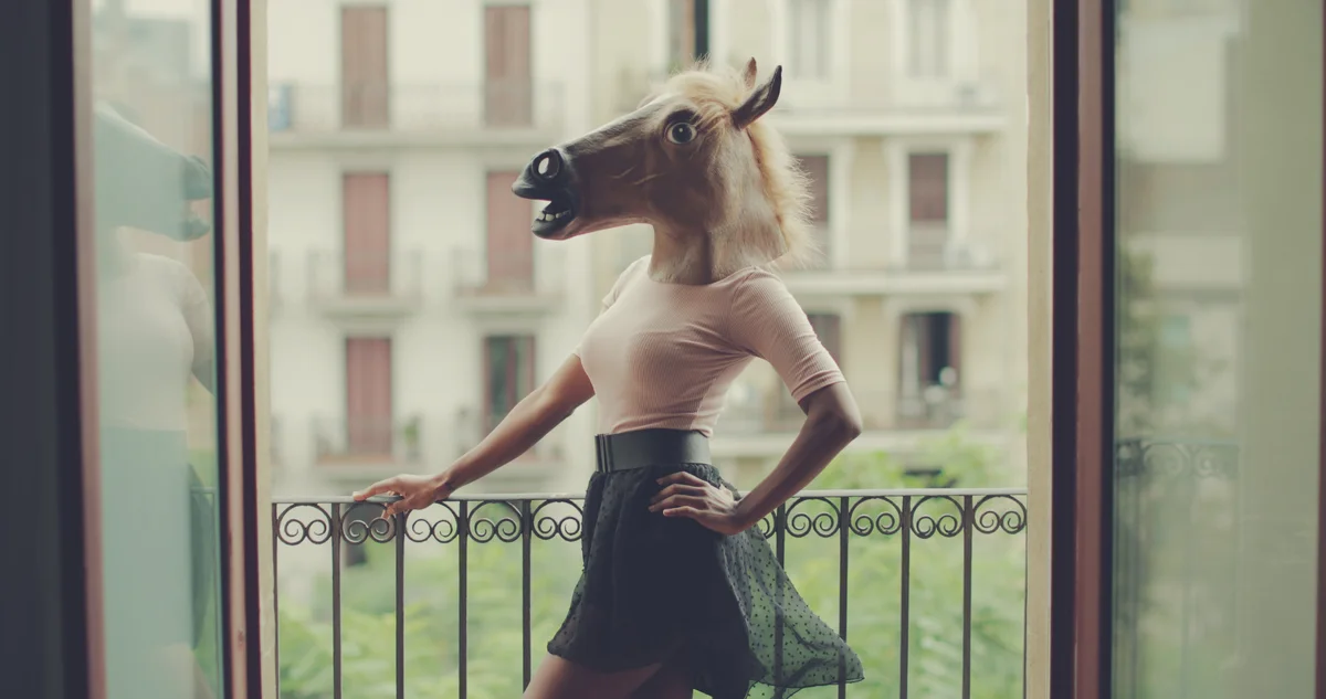 woman wearing a horse head