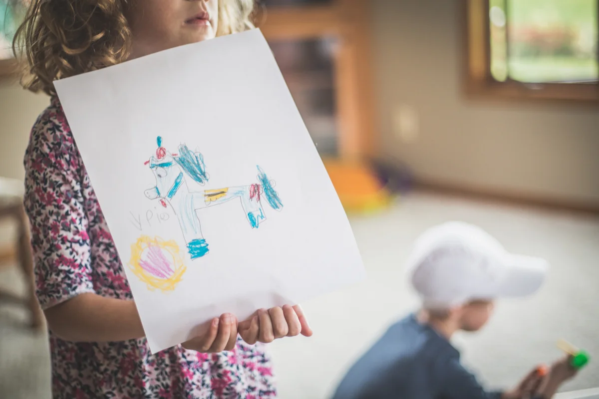 little girl with a horse drawing