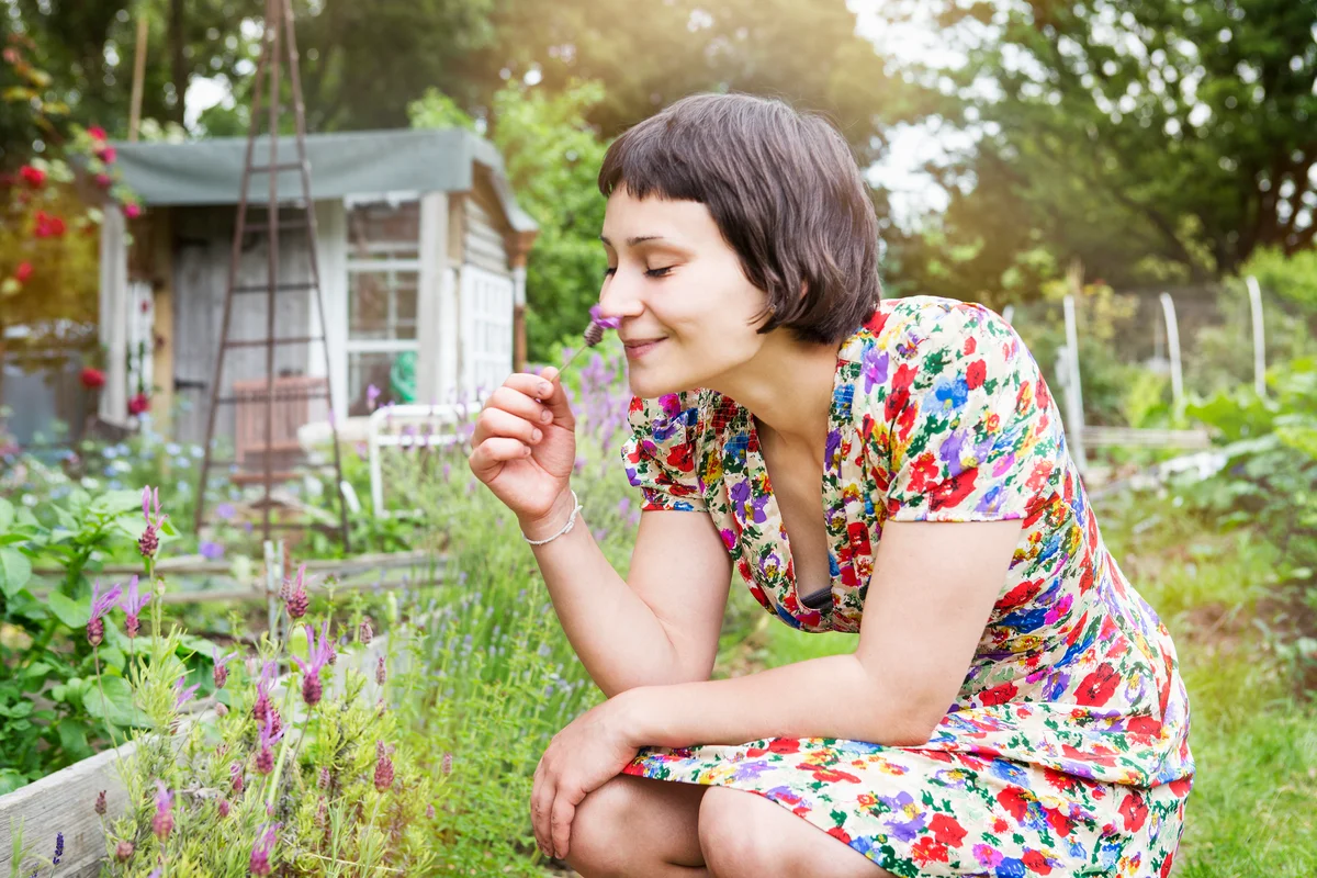 woman smelling a lavender flower
