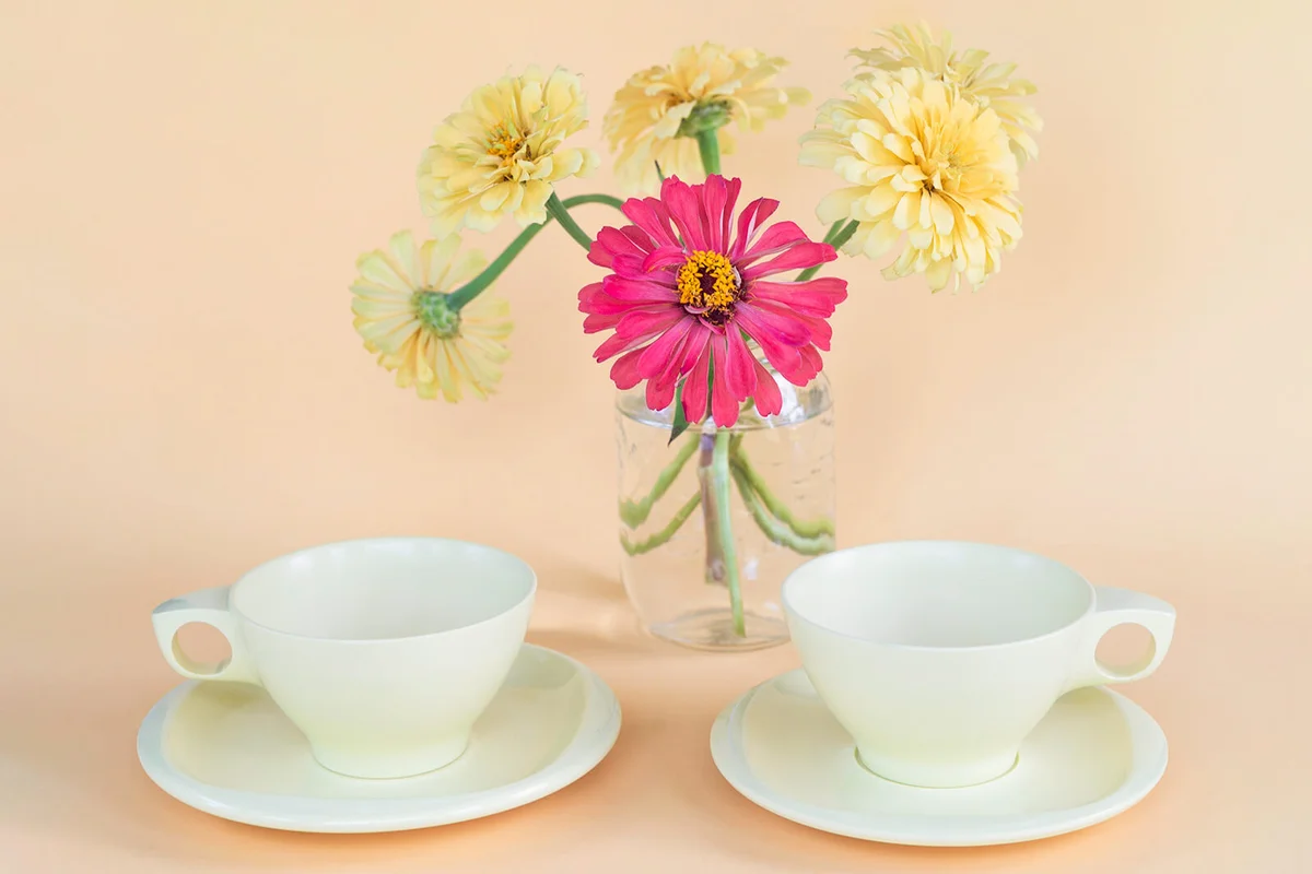 Two empty plastic yellow melmac cups